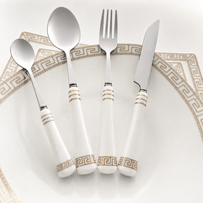 KitchBoom Cutlery Set featuring elegant white handles with gold detailing on a decorative plate