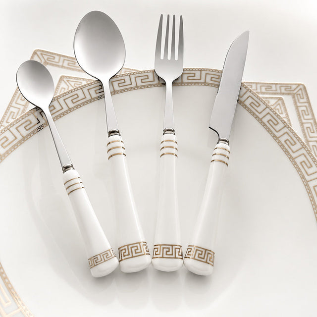KitchBoom Cutlery Set featuring elegant white handles with gold detailing on a decorative plate