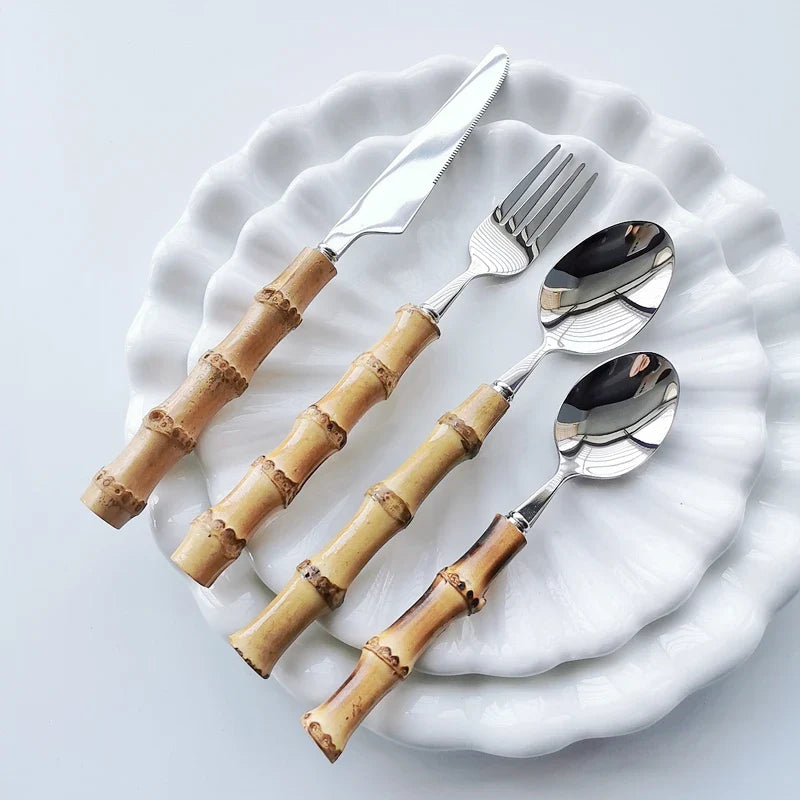 Nisu Home Cutlery Set with Bamboo Handles on White Plates for Elegant Dining