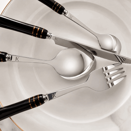 KitchBoom elegant cutlery set featuring stainless steel knife, fork, and spoon on a marble plate