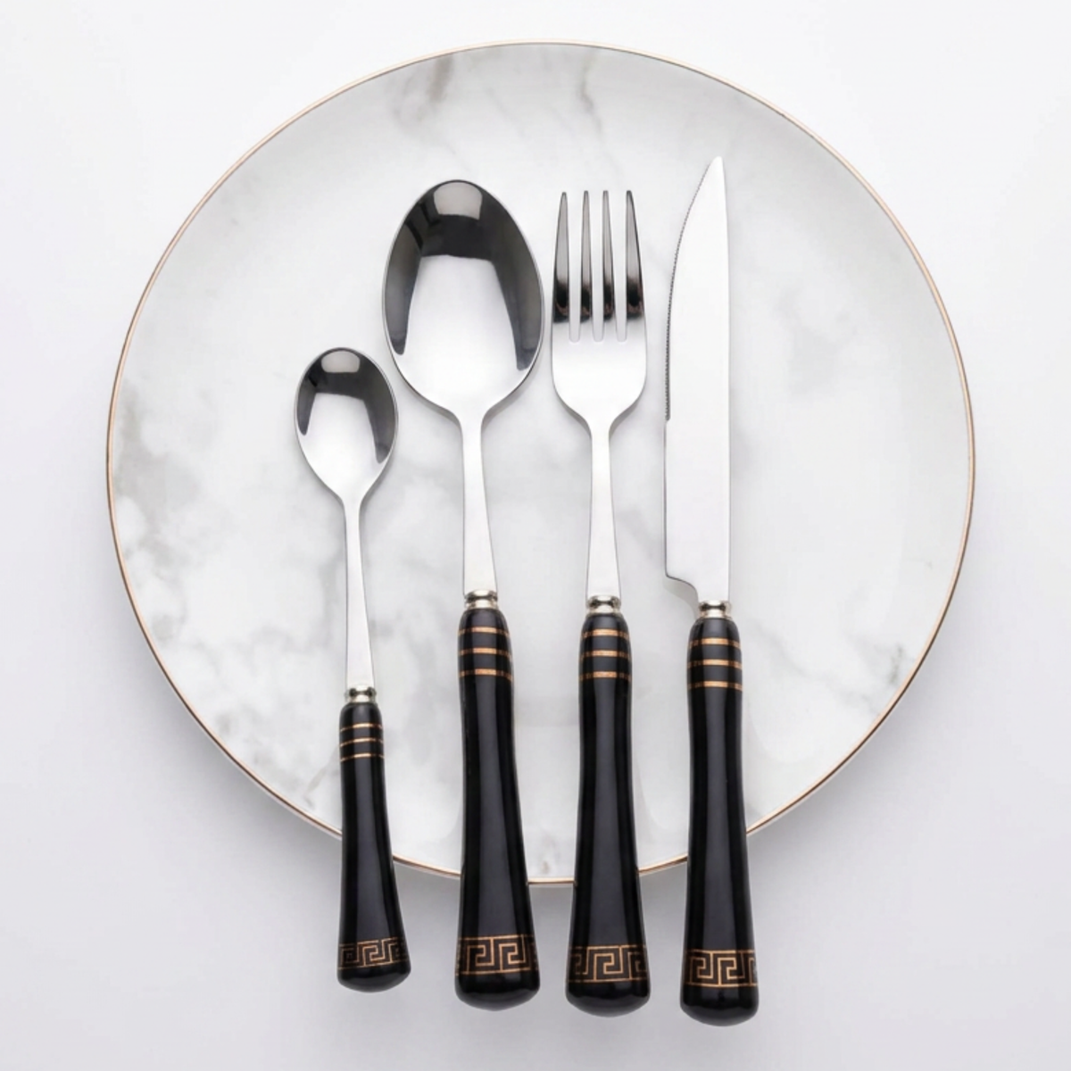 KitchBoom Cutlery Set in elegant black with gold accents on a marble plate
