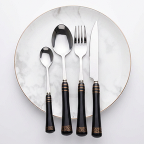 KitchBoom Cutlery Set in elegant black with gold accents on a marble plate