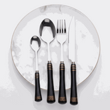 KitchBoom Cutlery Set in elegant black with gold accents on a marble plate