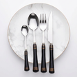 KitchBoom Elegant Cutlery Set with Black Handles on a Marble Plate for Dining Excellence