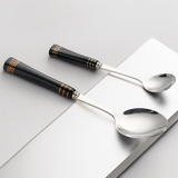 KitchBoom Cutlery Set featuring elegant black handles and shiny stainless steel spoons for stylish dining