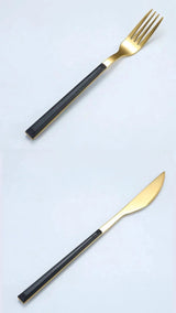 Elegant Nisu Home cutlery set featuring a gold fork and knife with sleek black handles