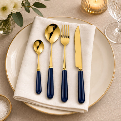 KitchBoom Gold Cutlery Set on a White Plate with Navy Handles for Elegant Dining