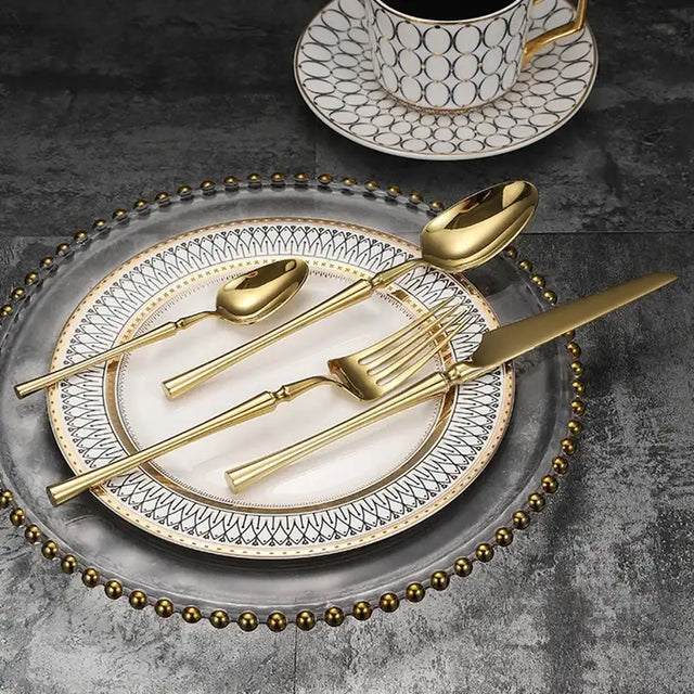 Elegant Nisu Home Cutlery Set in Gold on Decorative Plate for Stylish Dining Experience
