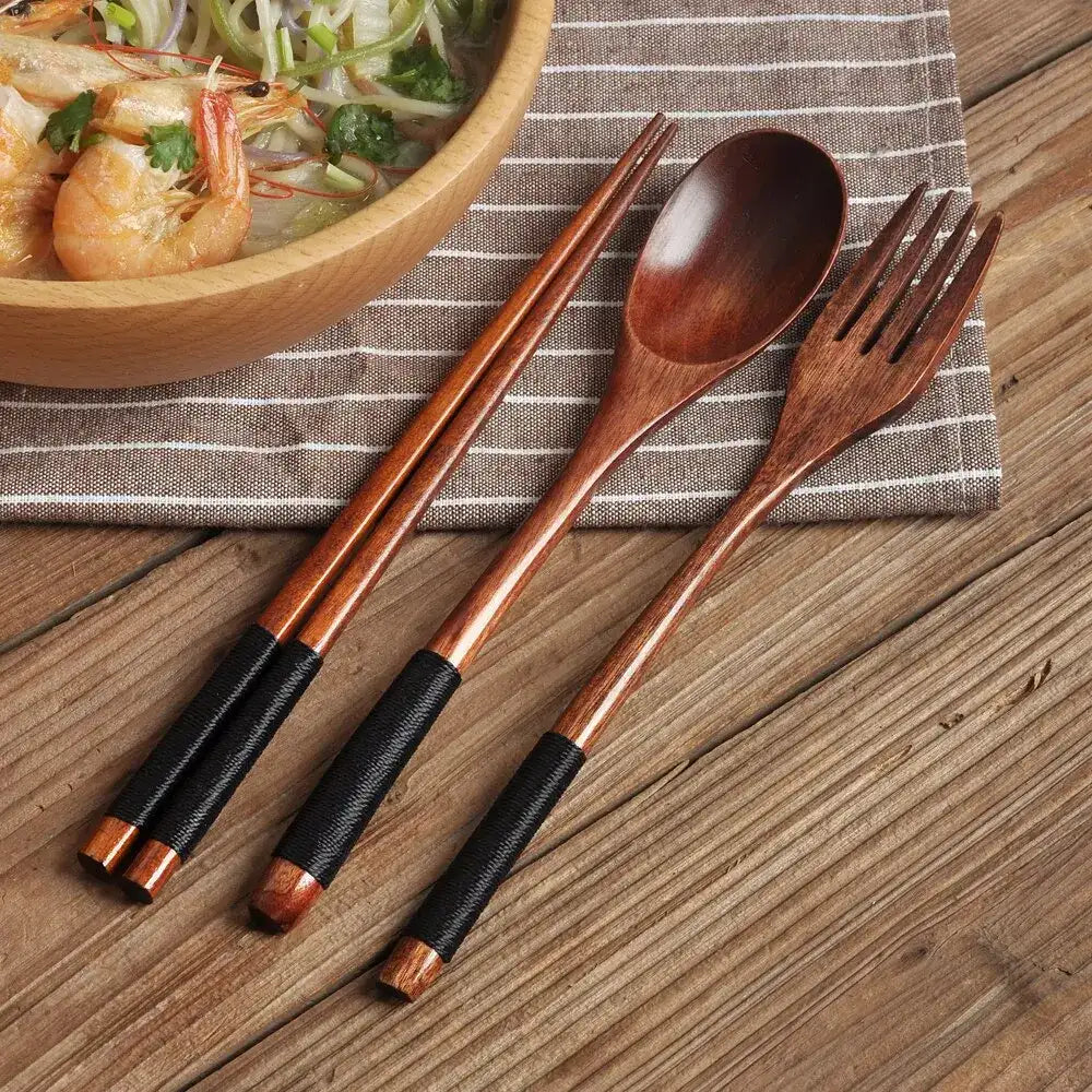 Nisu Home Cutlery Set featuring wooden chopsticks and serving spoon and fork on a table with noodles