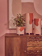 Stylish Orsina wall art featuring abstract shapes with decorative planters on a wooden dresser