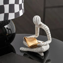 Decorative Nisu Home ornament of a figure reading a book, perfect for stylish home decor