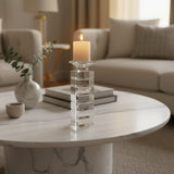 Elegant Orsina Candle Holder on a marble coffee table with a warm glowing candle