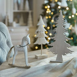 Decorative Christmas room decorations featuring a white rocking horse and wooden tree figurines