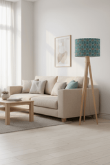 Stylish lampshade from Shadow Bright featuring a turquoise floral pattern on a wooden tripod floor lamp