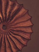Orsina decorative sculpture with intricate wood-like texture and ornate design in warm tones