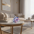 Elegant glass Swan figurine in pink and blue resting on a stylish coffee table