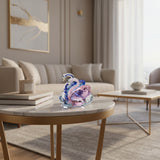 Elegant glass Swan figurine in pink and blue resting on a stylish coffee table