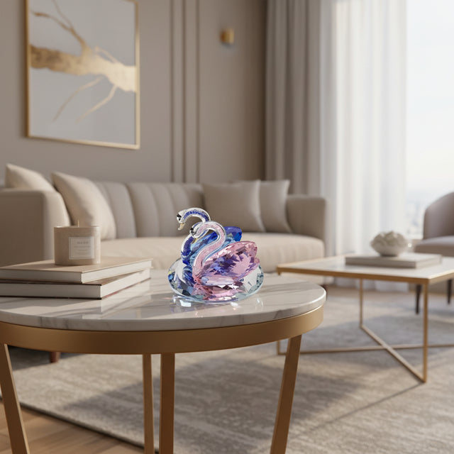 Elegant glass Swan figurine in pink and blue resting on a stylish coffee table