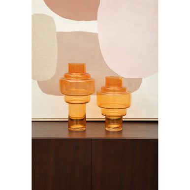 Elegant Orsina Wall Art featuring soft geometric shapes in warm tones behind two amber glass vases.