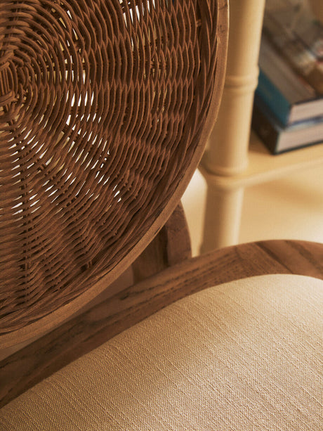 Close-up of Orsina Dining Chair featuring a woven backrest and soft fabric seat