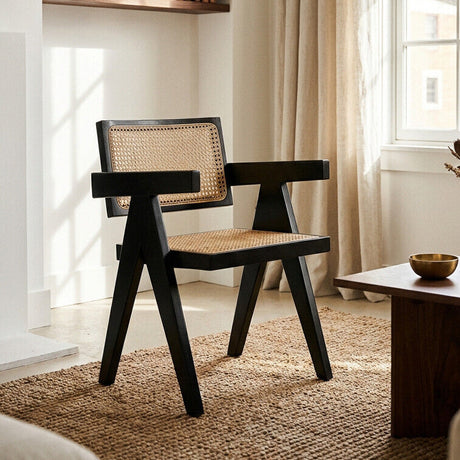 Orsina Dining Chair with a black frame and woven rattan seat for modern homes