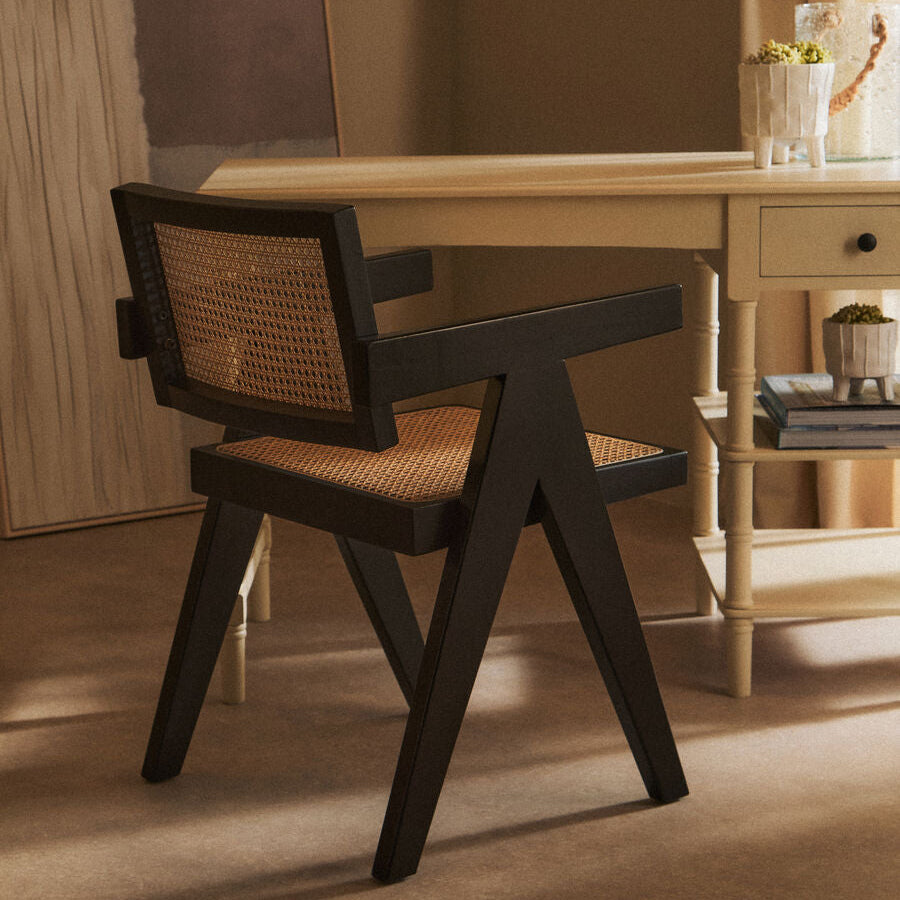 Orsina Dining Chair with a modern design featuring a black frame and woven seat for stylish dining