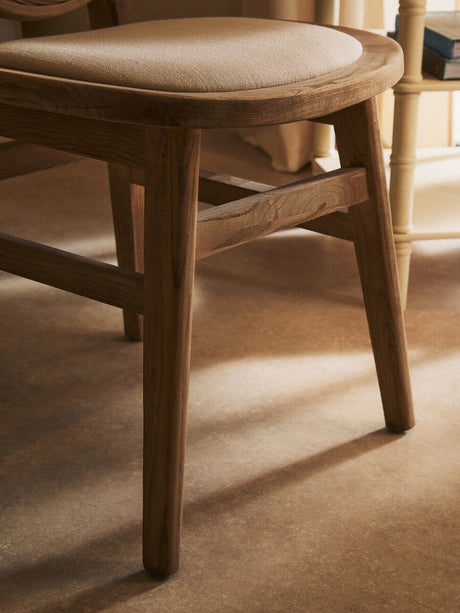 Orsina Dining Chair with a smooth wooden frame and cushioned seat for comfortable dining