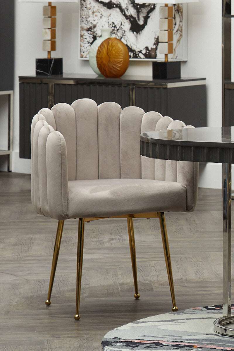 Orsina Dining Chair with tufted upholstery and golden legs, perfect for modern dining spaces