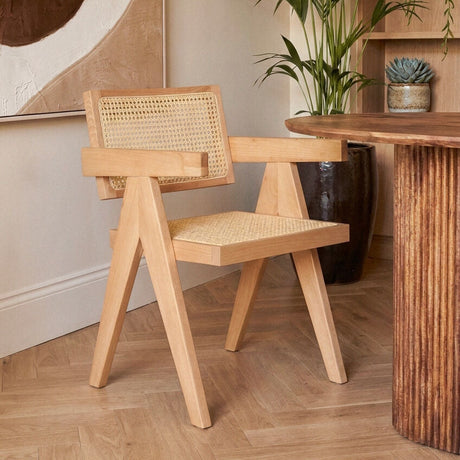 Orsina Dining Chair with a wooden frame and woven cane backrest in a modern interior setting