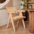 Orsina Dining Chair with a wooden frame and woven cane backrest in a modern interior setting