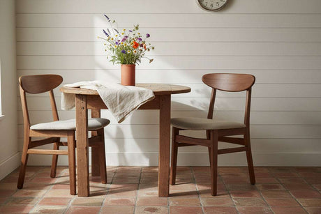 Fishe and Lilly Dining Chair in natural wood finish, paired with a round table and floral decor