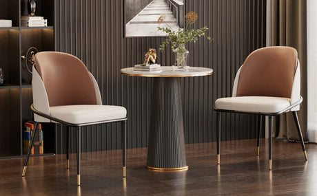 Two Klassyx dining chairs with modern design, paired with a stylish circular table in a contemporary setting