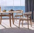 Nisu Home chair with a modern design, paired with a round table and scenic ocean view