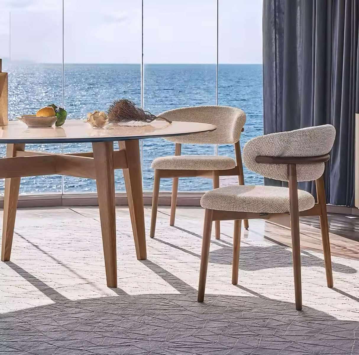 Nisu Home chair with a modern design, paired with a round table and scenic ocean view