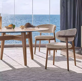 Nisu Home chair with a modern design, paired with a round table and scenic ocean view