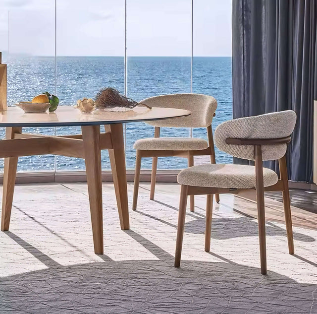 Nisu Home chair with a modern design, paired with a round table and scenic ocean view