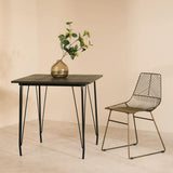 Orsina Dining Table with Elegant Design and Black Metal Legs, Surrounded by a Stylish Chair