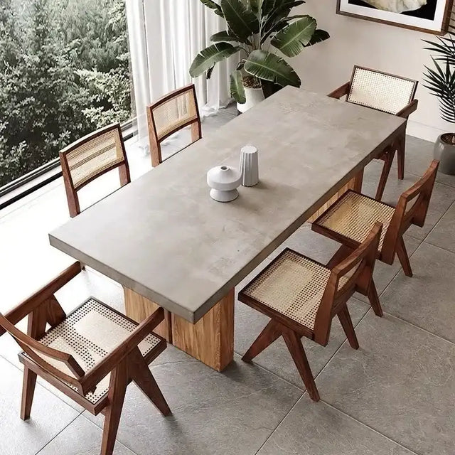 Nisu Home Dining Table with a modern concrete top and wooden base surrounded by stylish chairs
