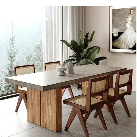 Nisu Home Dining Table with a sleek concrete top and wooden base, surrounded by stylish chairs