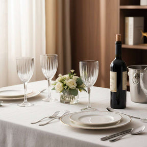 Elegant Orsina Wine Glasses on a dining table with a wine bottle and floral centerpiece