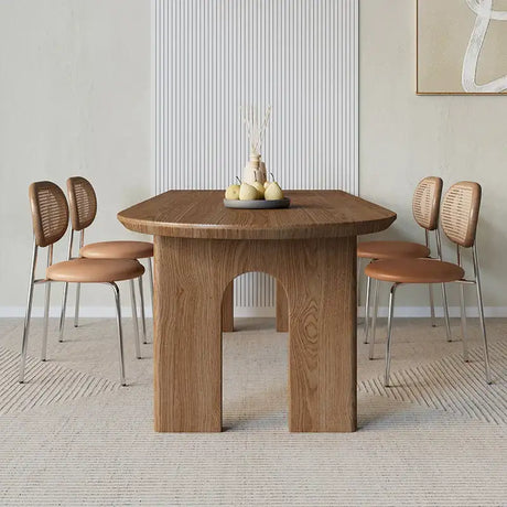 Nisu Home modern oak dining table with curved edges, surrounded by stylish dining chairs