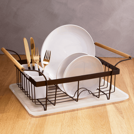 Orsina Dish Drainer with white plates and gold cutlery on a wooden countertop