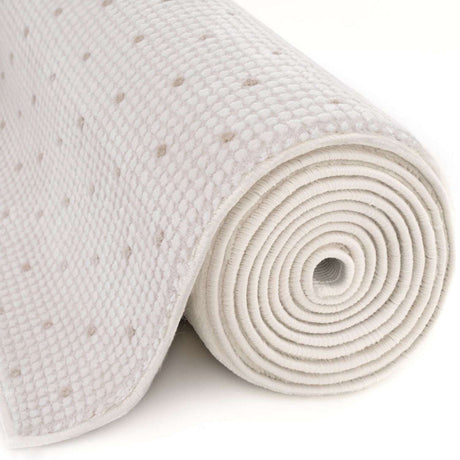 Soft cream Dots Rug rolled up, featuring a subtle dotted texture for modern interiors