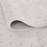 Close-up of a soft Dots Rug with a textured surface in neutral tones, ideal for any home decor