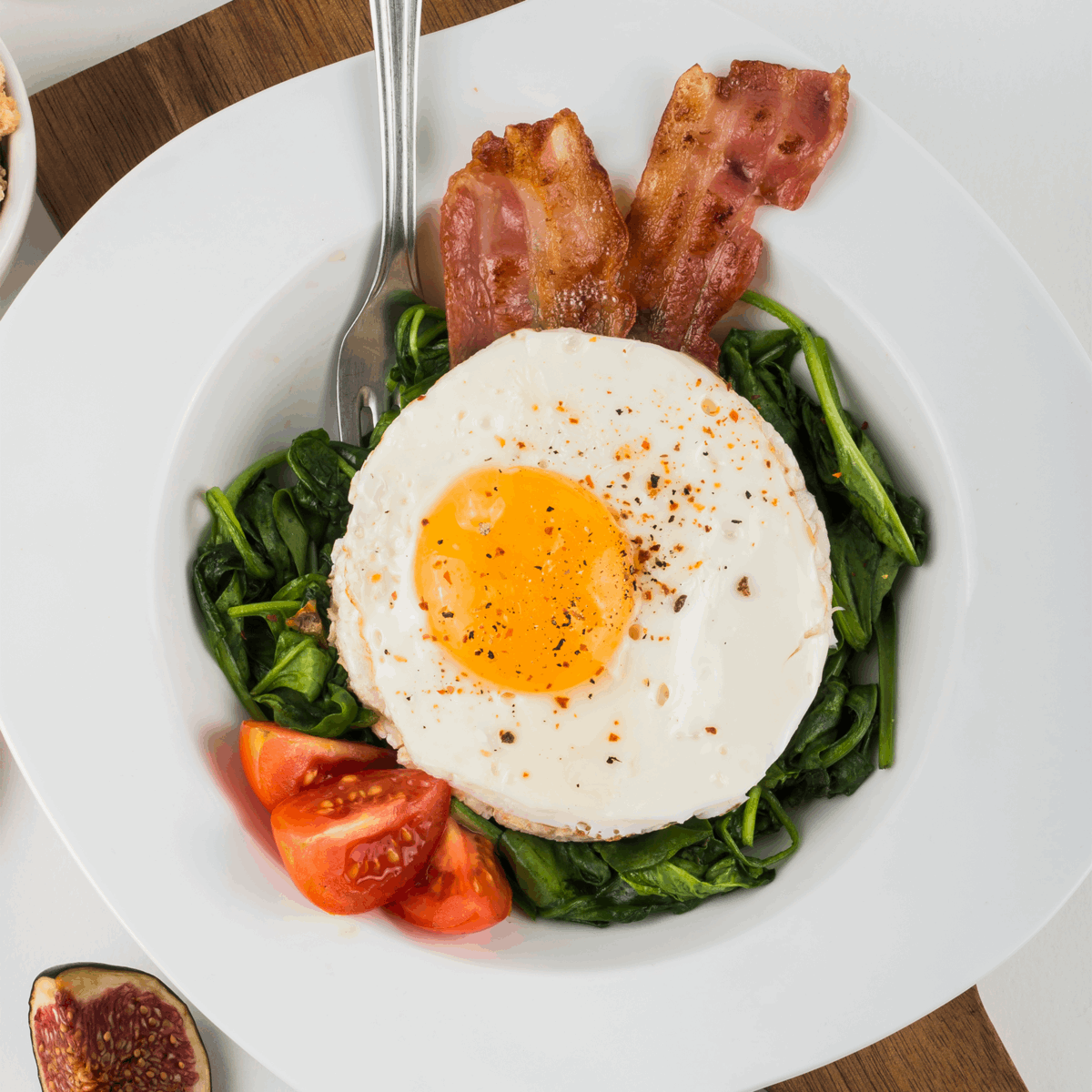Orsina Egg Rings for perfectly shaped eggs on a plate with spinach, bacon, and tomatoes