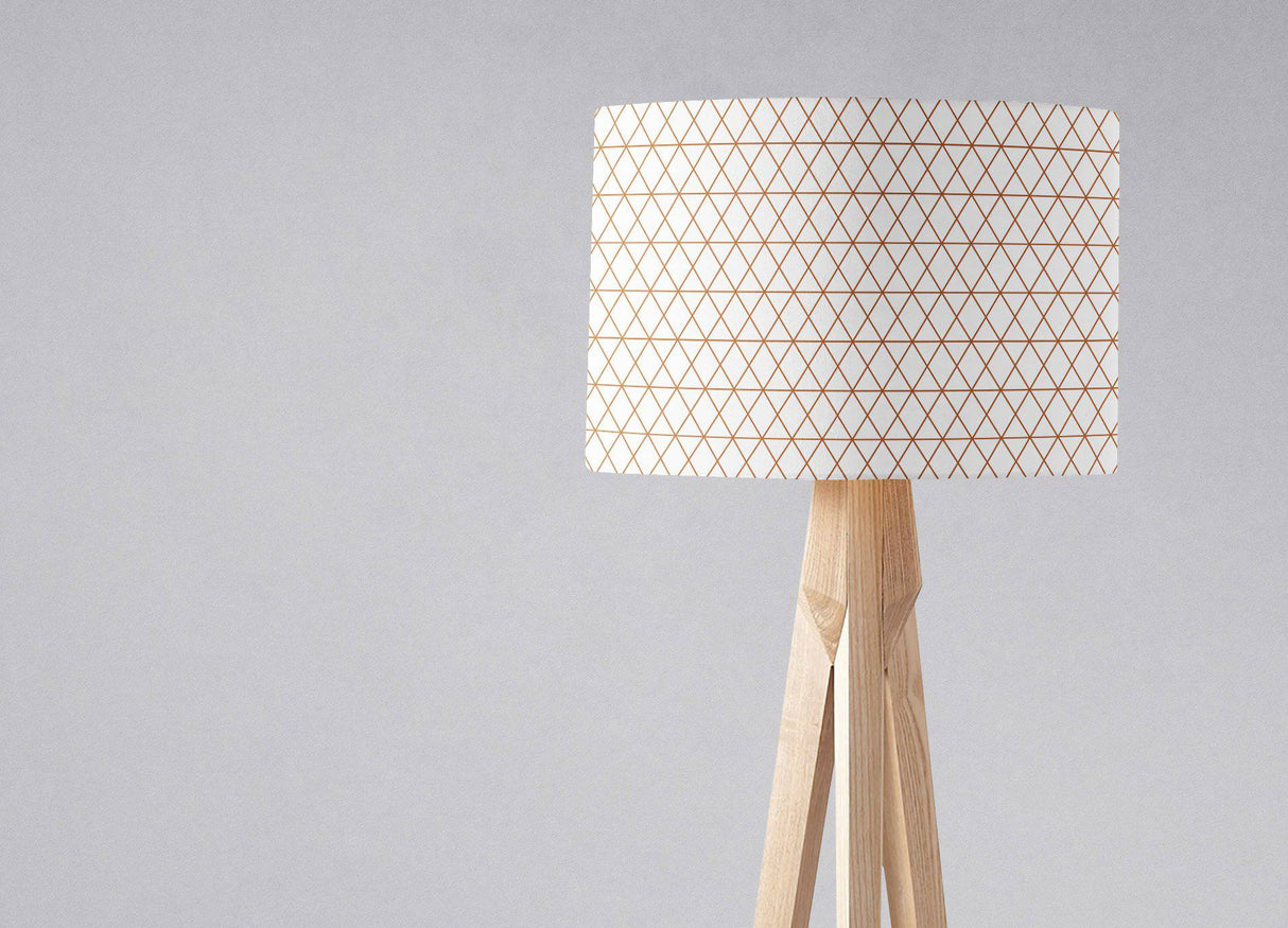 Stylish lampshade by Shadow Bright with a geometric design on a wooden tripod lamp