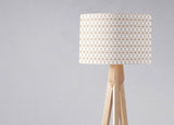 Stylish lampshade by Shadow Bright with a geometric design on a wooden tripod lamp