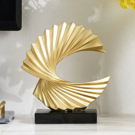 Elegant gold swirl ornament by Nisu Home, showcasing a modern design and textured finish