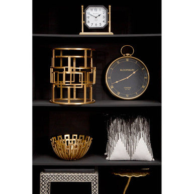 Orsina Embroidered Cushion displayed on a stylish bookshelf with decorative items