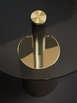 Orsina End Table featuring a sleek gold base and round glass top, perfect for modern living spaces